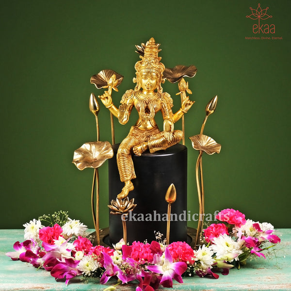 Brass Goddess Lakshmi Sitting Idol on Wooden Pedestal with Flowers